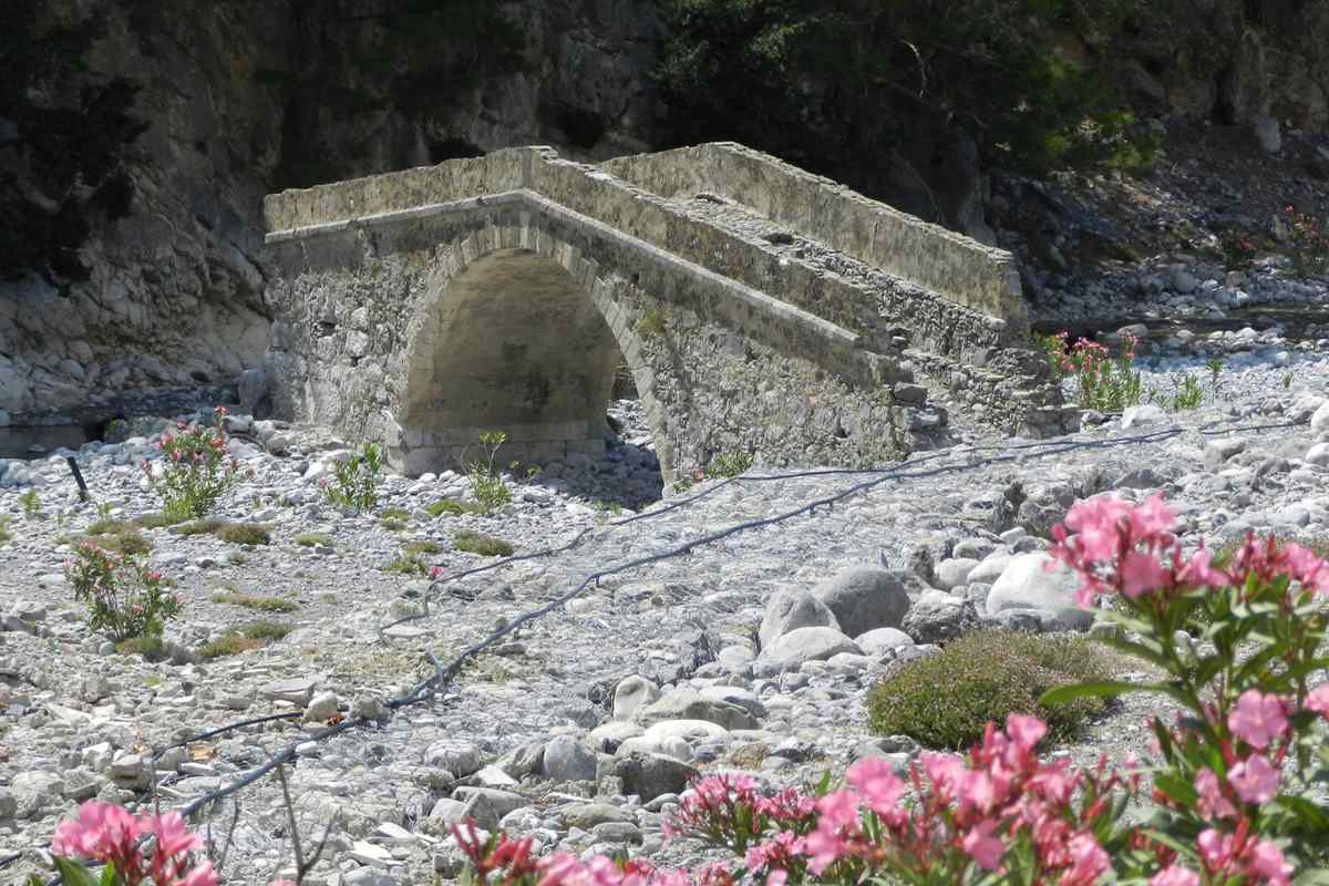 The old stone bridge among oleanders at Agia Roumeli, where a Samaria gorge day trip from Rethymno reaches the coast