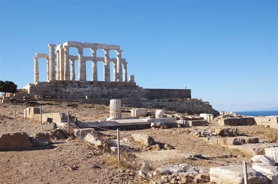 The Temple of Poseidon above the foundations of the ancient sanctuary on the headland, explained on a Sounion guided tour.