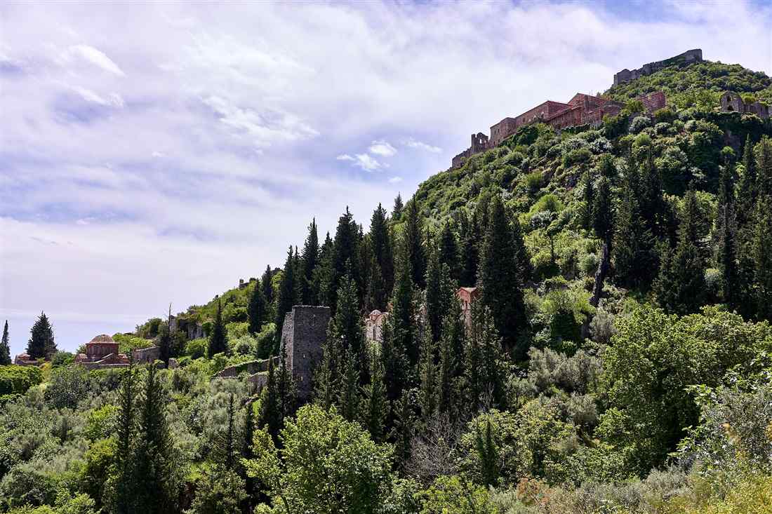 The Palace of the Despots and the castle on the hillside of Mystras above the cypress trees, the Byzantine town added to a Sparta day trip.