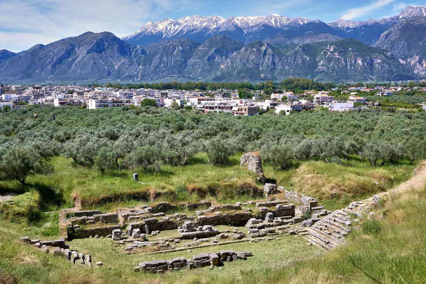 Sparta tours at the ancient theatre of Sparta with the modern town, olive groves and the snow on Mount Taygetos