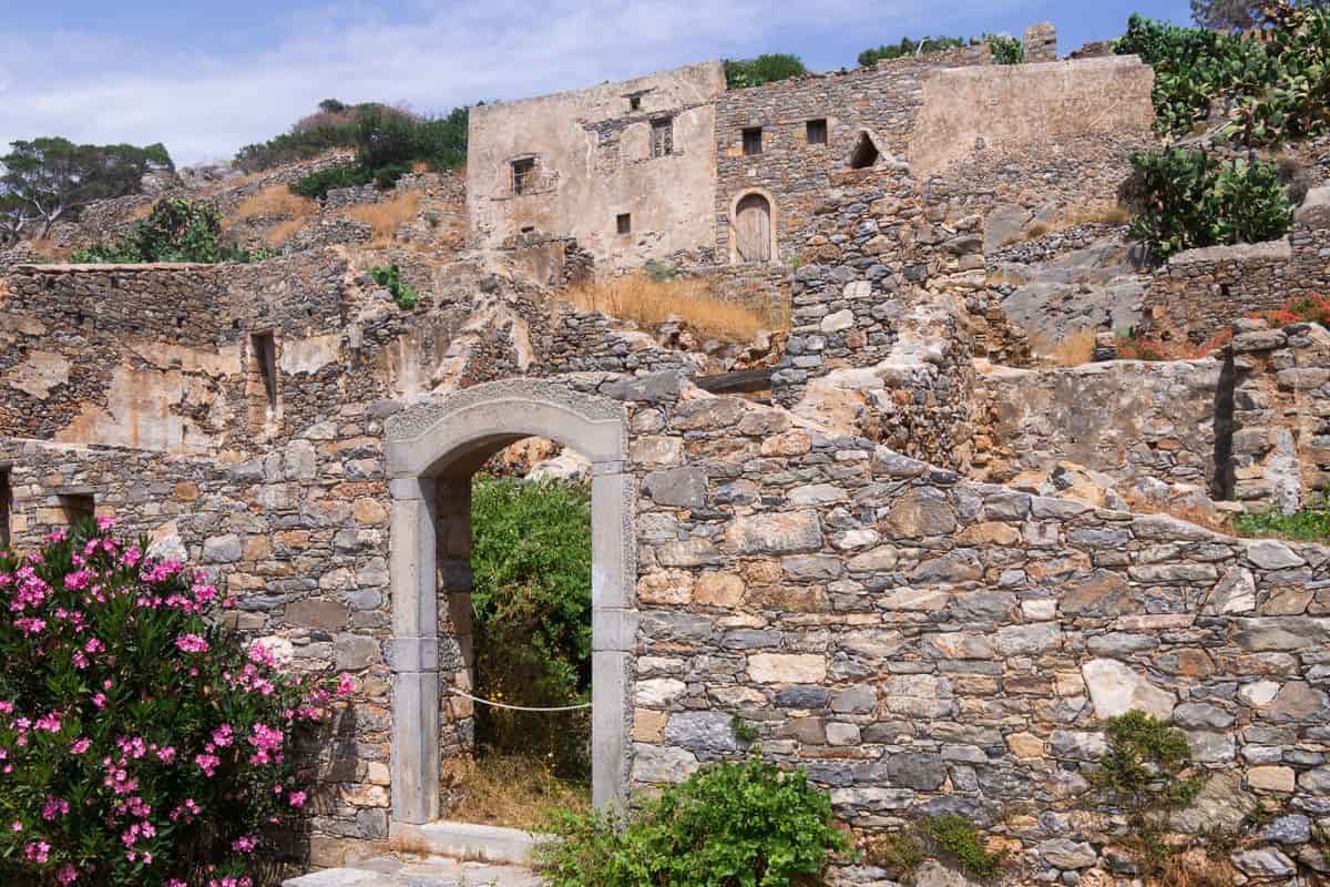 Stone ruins and a gateway inside the fortress, seen on a Spinalonga day trip from Heraklion
