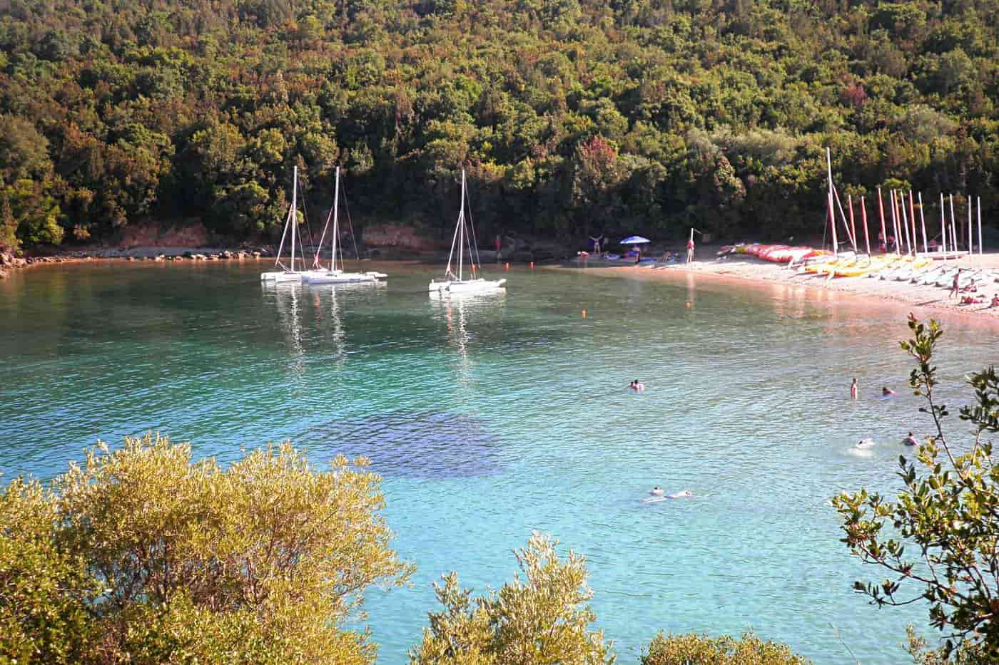 Syvota tours at a turquoise cove of Syvota with sailing boats at anchor