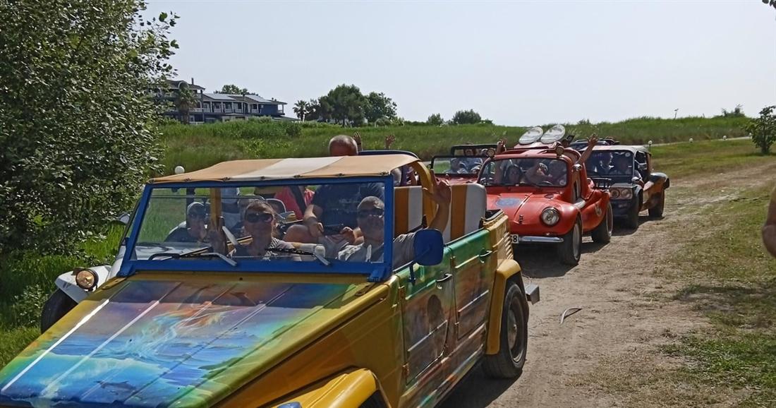 A convoy of open safari jeeps on a dirt track, the vehicles of the Discover Olympus buggy safari from Thessaloniki.