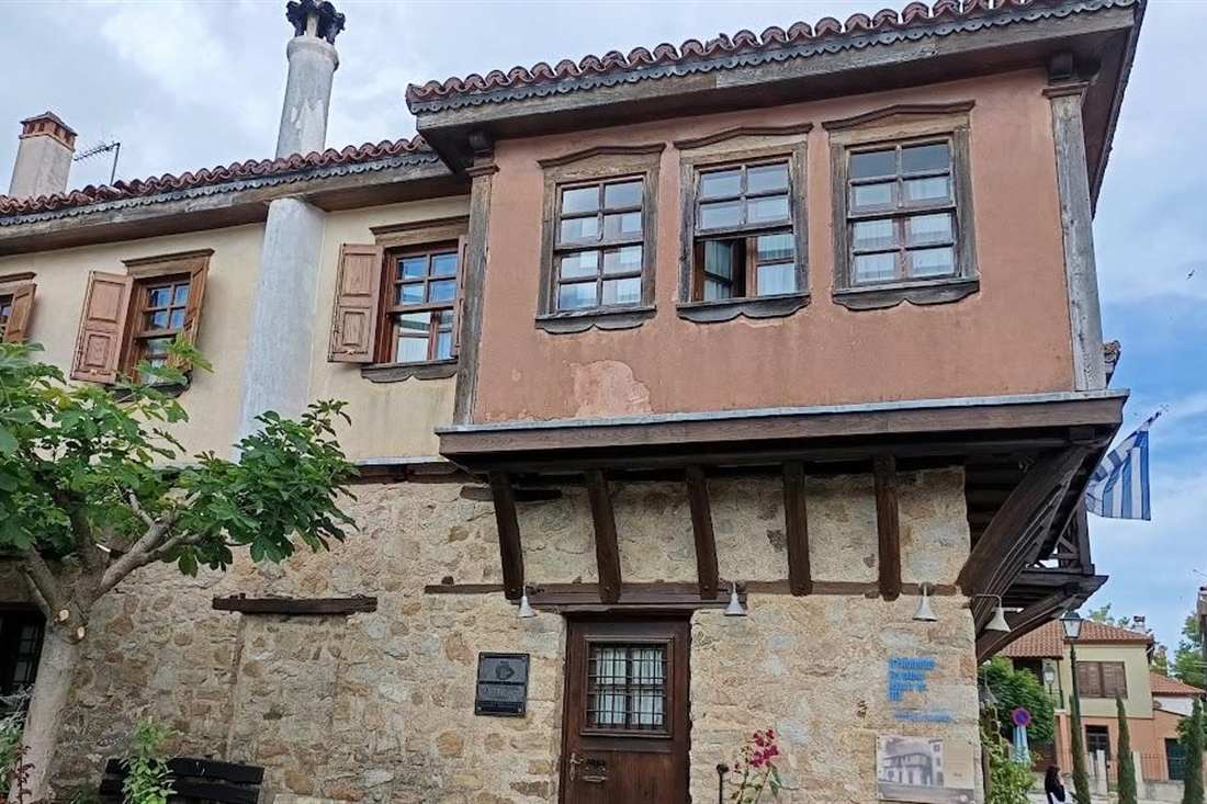 A two-storey traditional Macedonian house with a timber-framed upper floor, wooden shutters and a stone ground floor in a hill village on a Thessaloniki traditional villages tour.